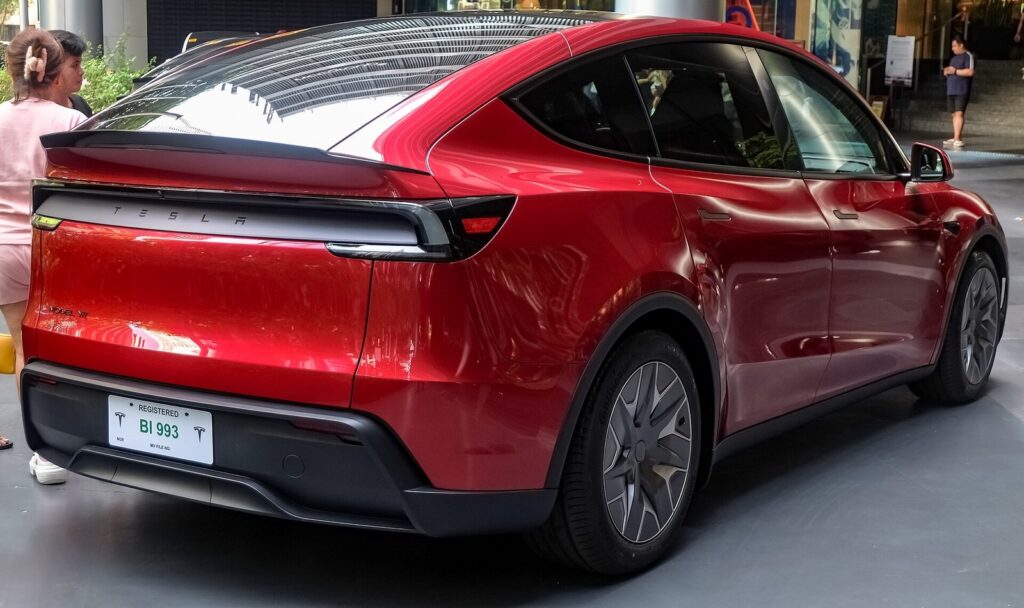 Tesla Model Y L Ultra Red rear three-quarter view