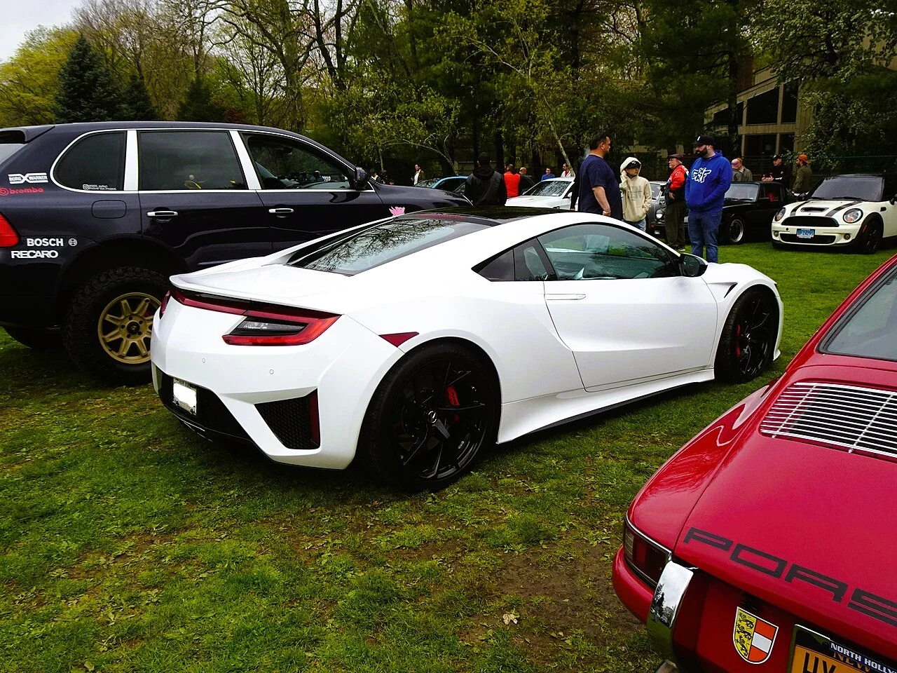 White Acura NSX rear three-quarter at an event