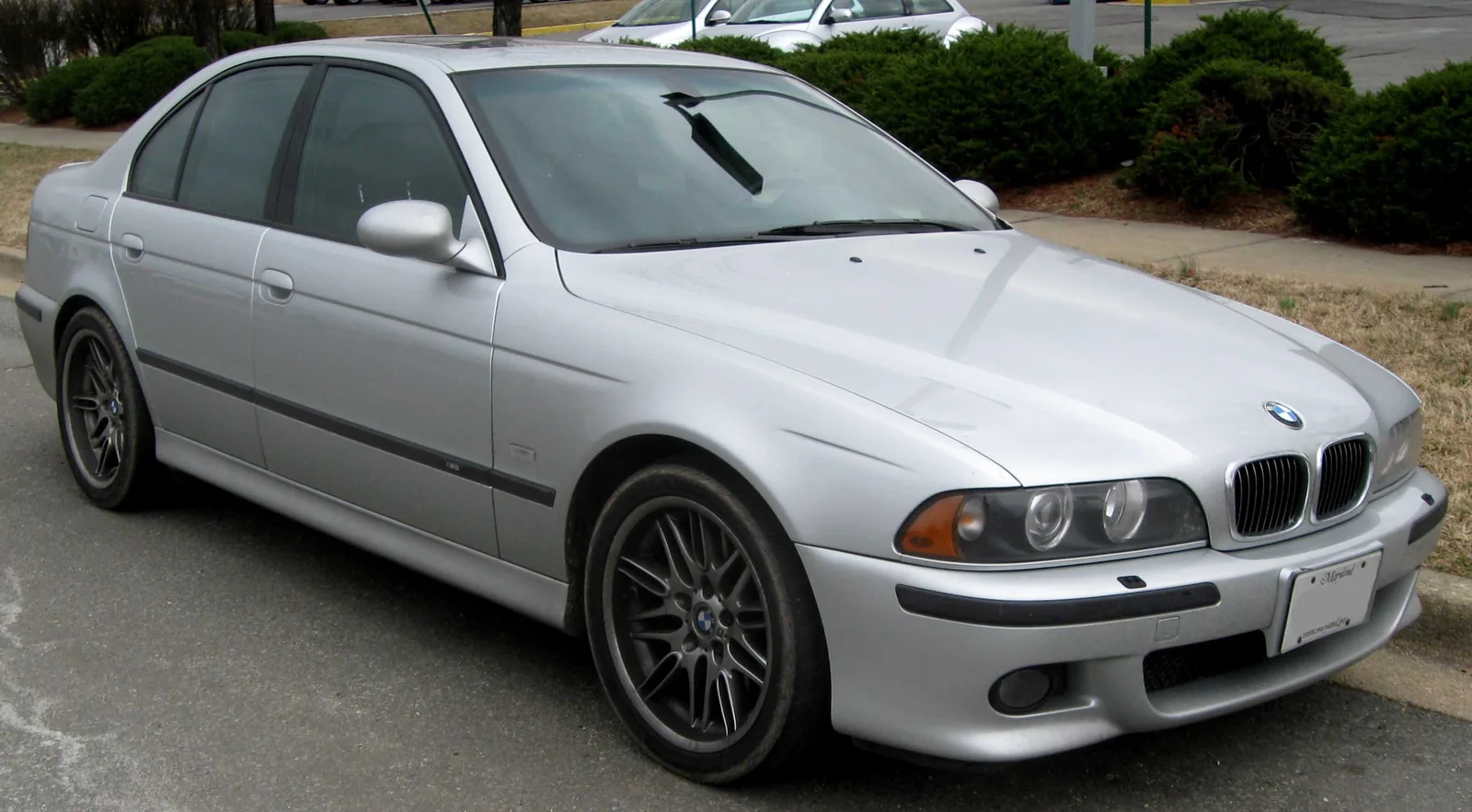 silver BMW E39 M5 parked on a residential street