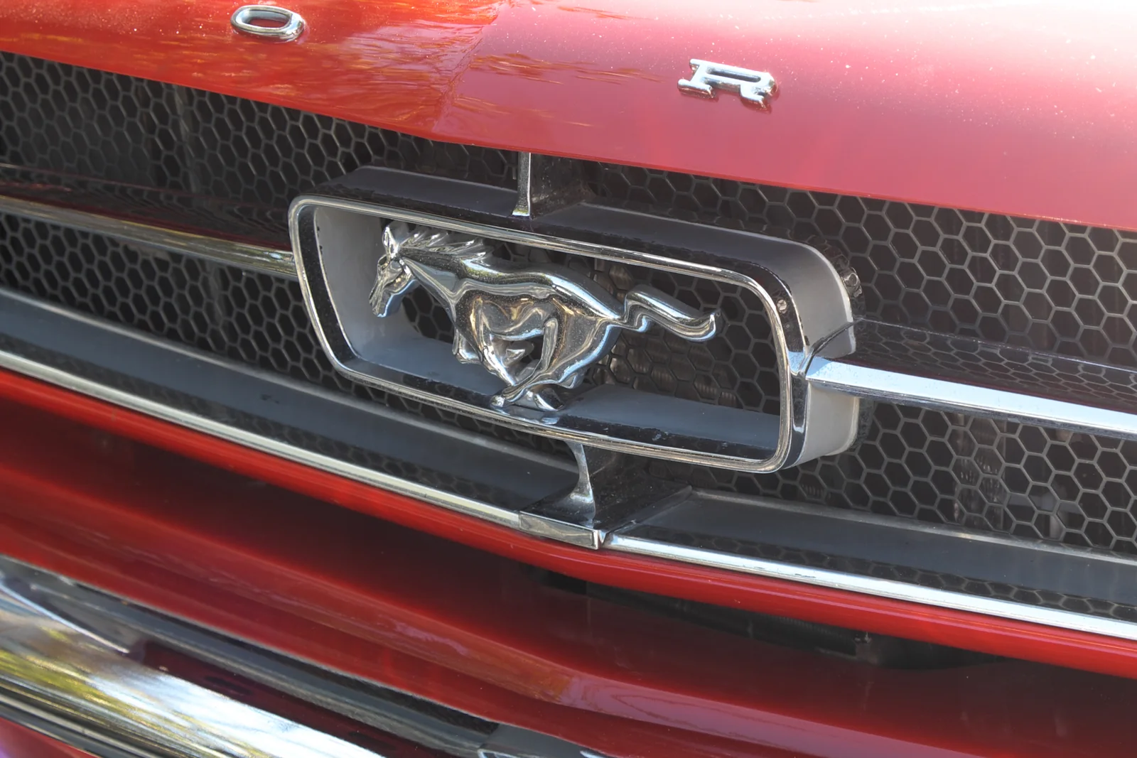 Ford Mustang grille badge showing the running horse emblem