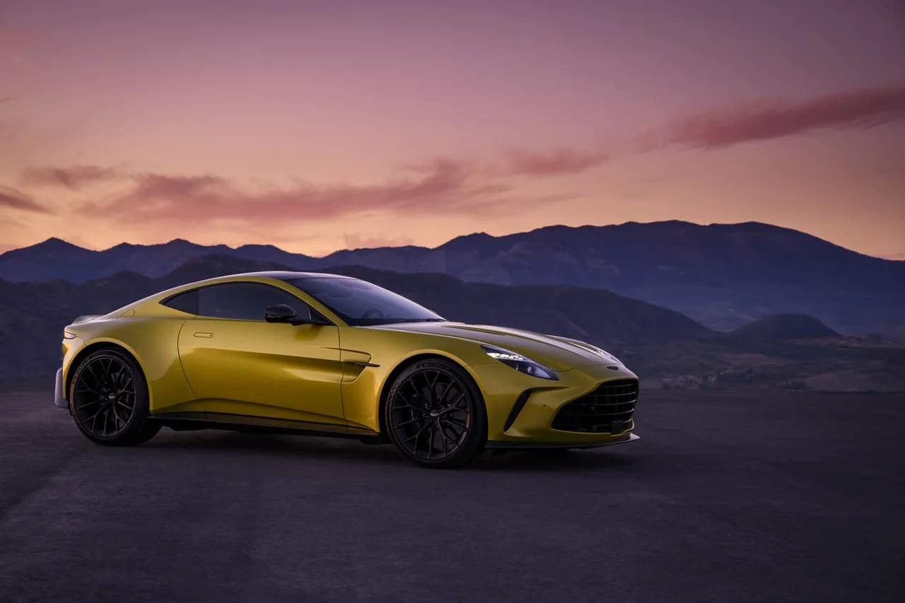 Yellow Aston Martin Vantage in front three-quarter view at sunset
