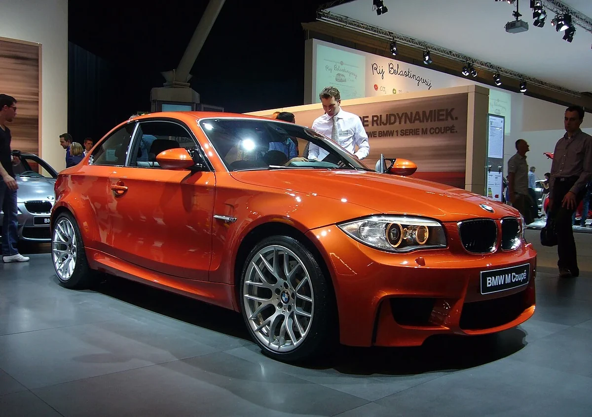 Orange BMW 1M Coupe at an indoor display