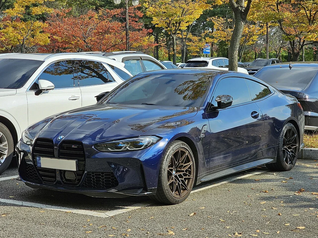 Blue BMW M4 Competition in a street setting