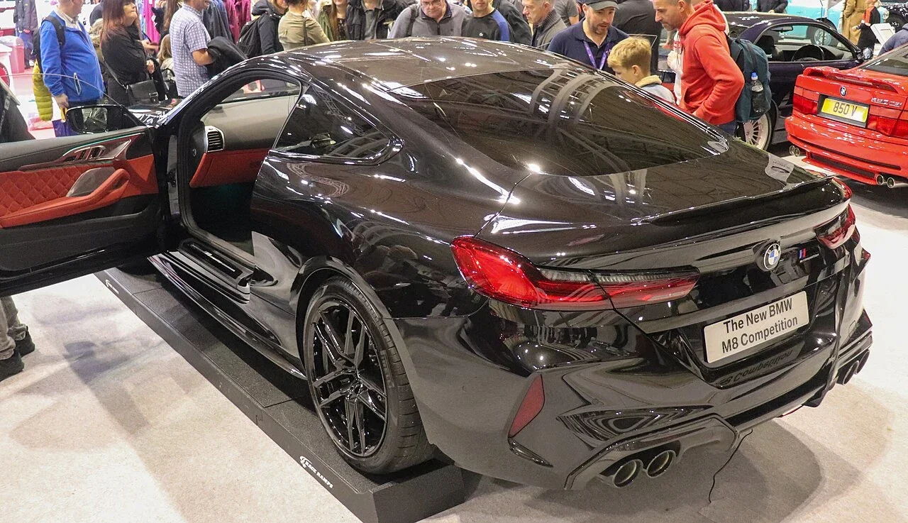 BMW M8 Competition coupe with door open at a show