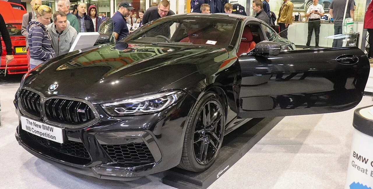 Black BMW M8 Competition coupe at a public display