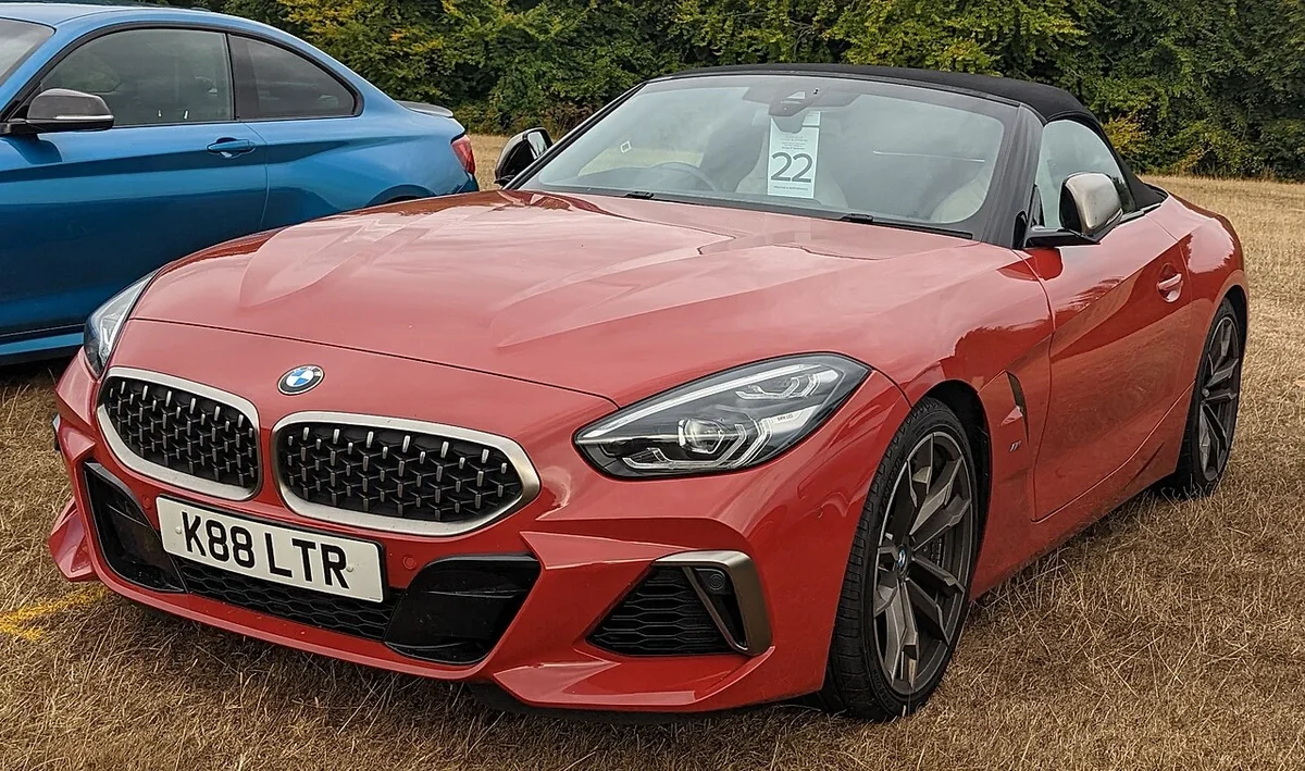 Red BMW Z4 M40i automatic at an outdoor gathering