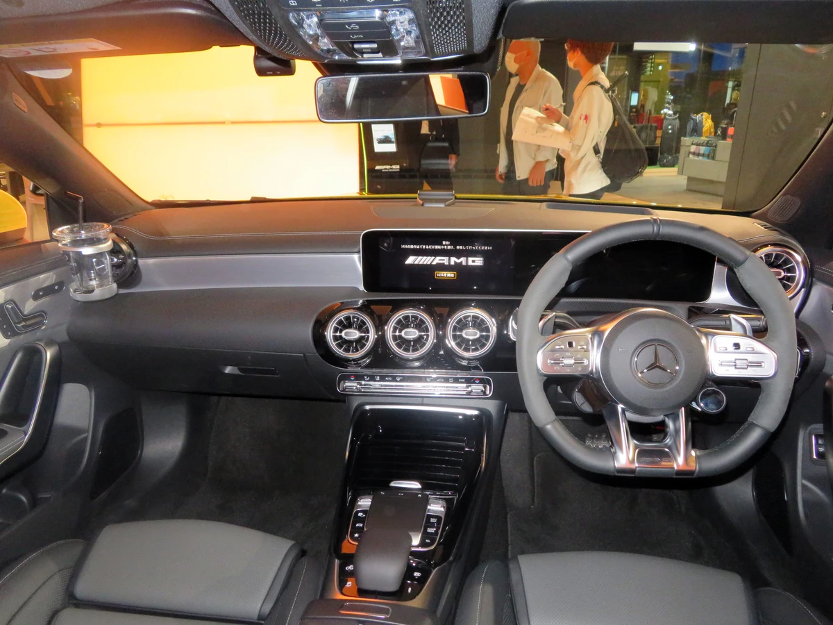 2020 right-hand-drive Mercedes-AMG CLA 45 S dashboard with round vents and a console touchpad