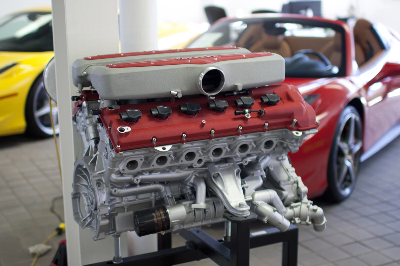 Ferrari F140C V12 engine from a 599 GTB Fiorano on a display stand