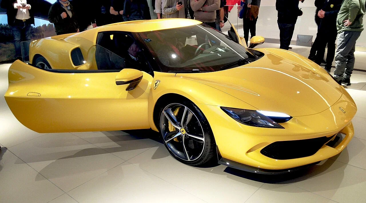 Yellow Ferrari 296 GTB displayed with its driver door open