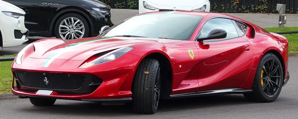 Red Ferrari 812 Superfast coupe with front wheels turned