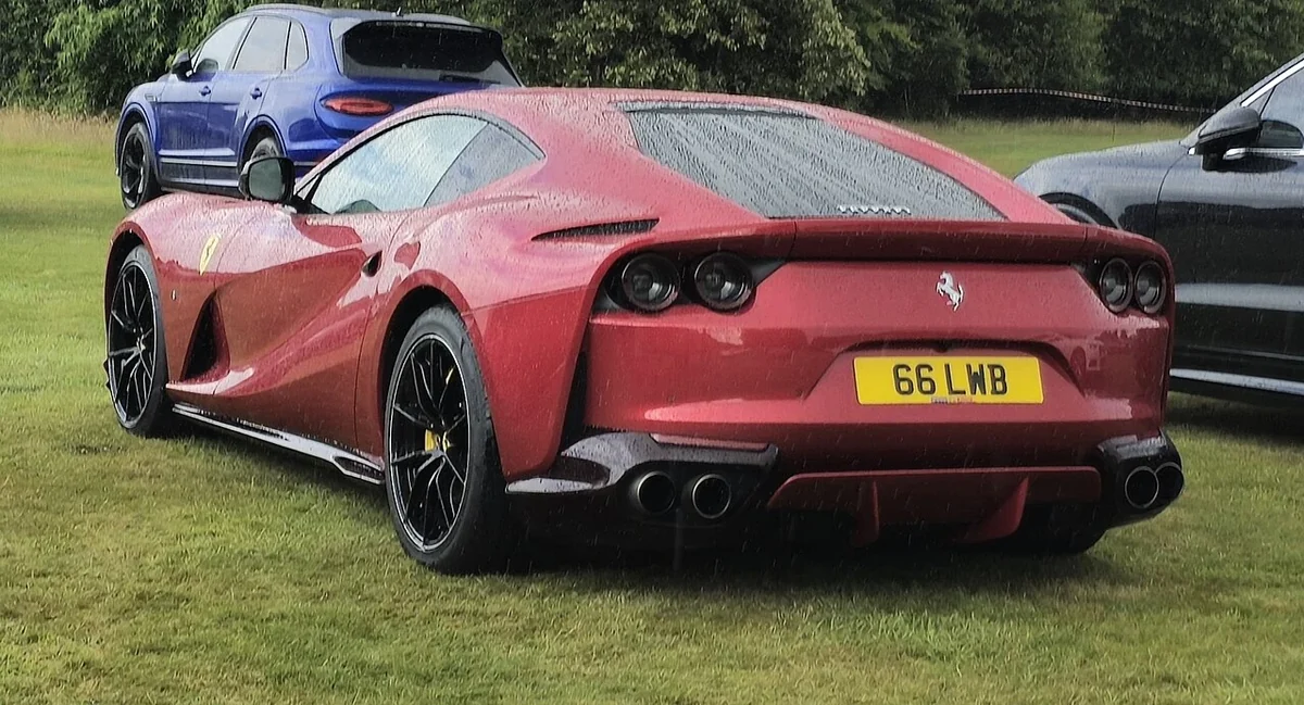 Red Ferrari 812 Superfast rear three-quarter at a gathering