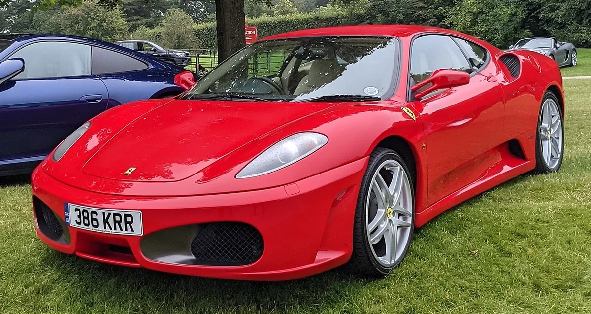 Red 2005 Ferrari F430 parked at a gathering