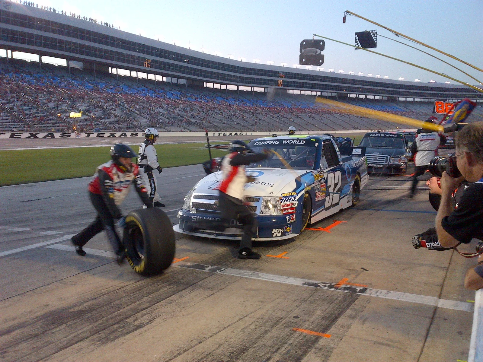 NASCAR pit crew changing tires during a pit stop at Texas Motor Speedway