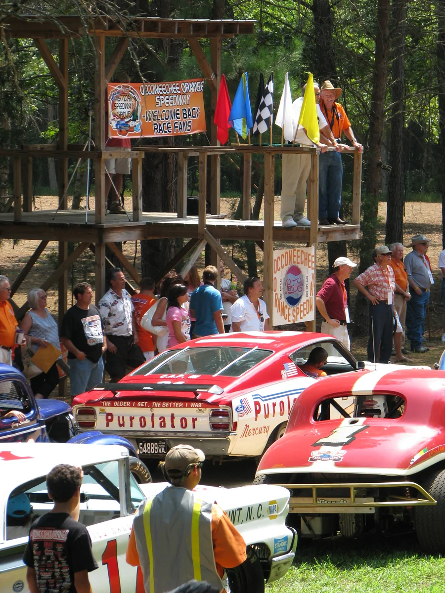historic NASCAR-style flag stand with race cars below