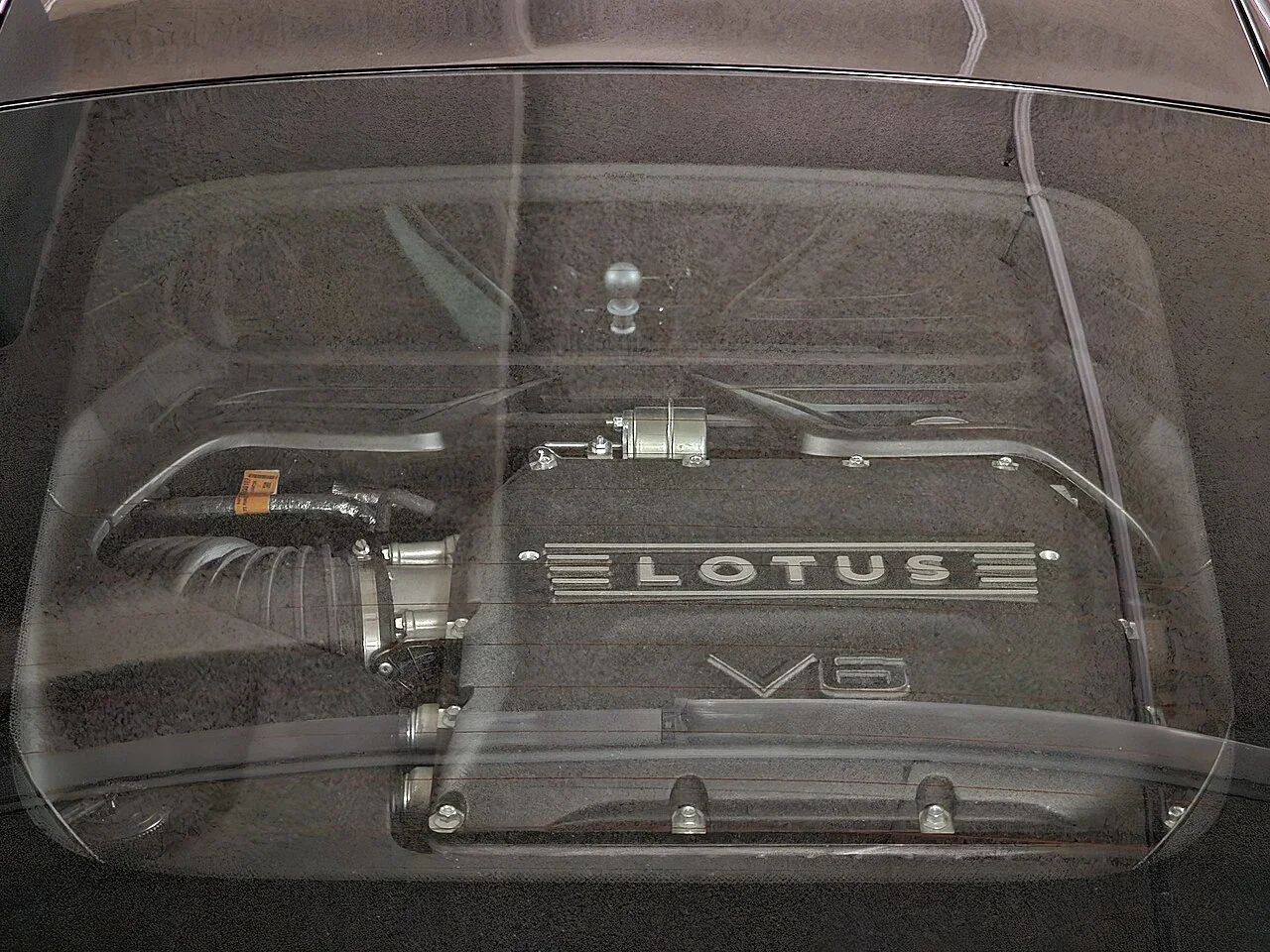 Lotus Emira V6 engine installation seen through the rear glass