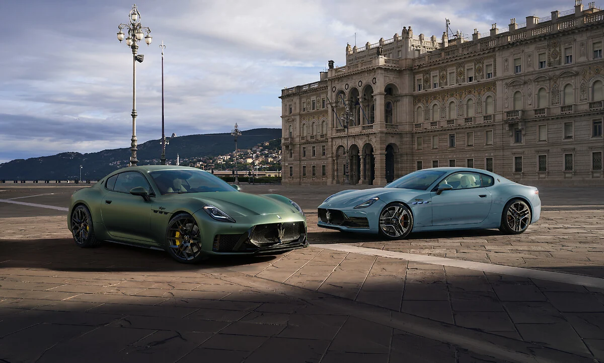 Green 2027 Maserati GranTurismo Trofeo beside a silver GranTurismo in Trieste