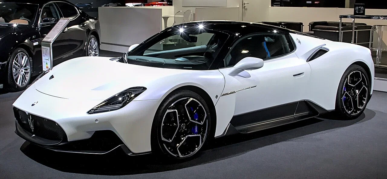 White Maserati MC20 original coupe at a motor show