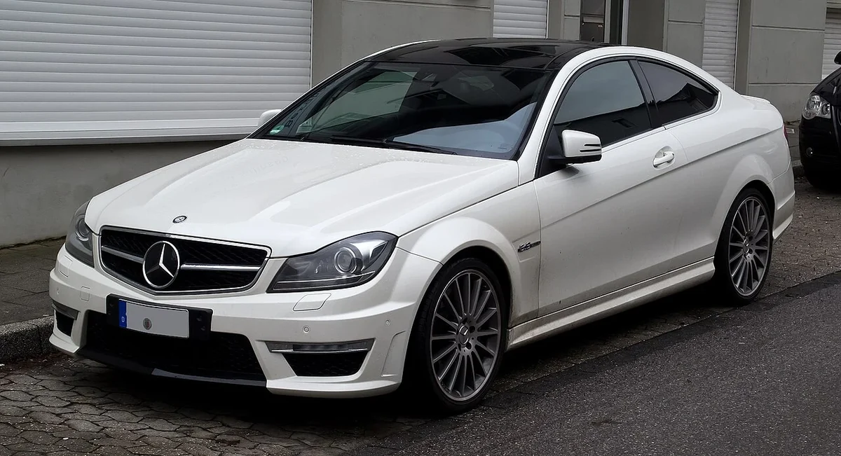 White Mercedes C63 AMG C204 coupe front three-quarter view