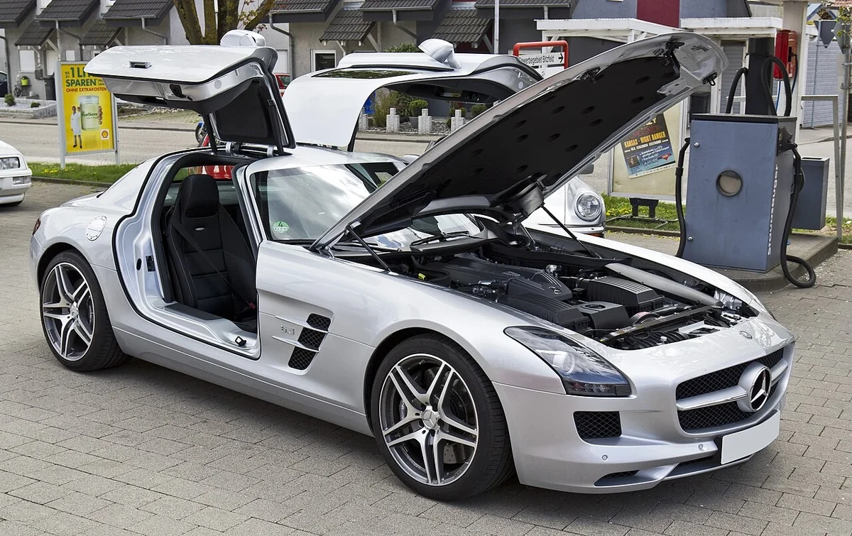 Gullwing doors and hood open on an original SLS AMG; access is part of the ownership experience.