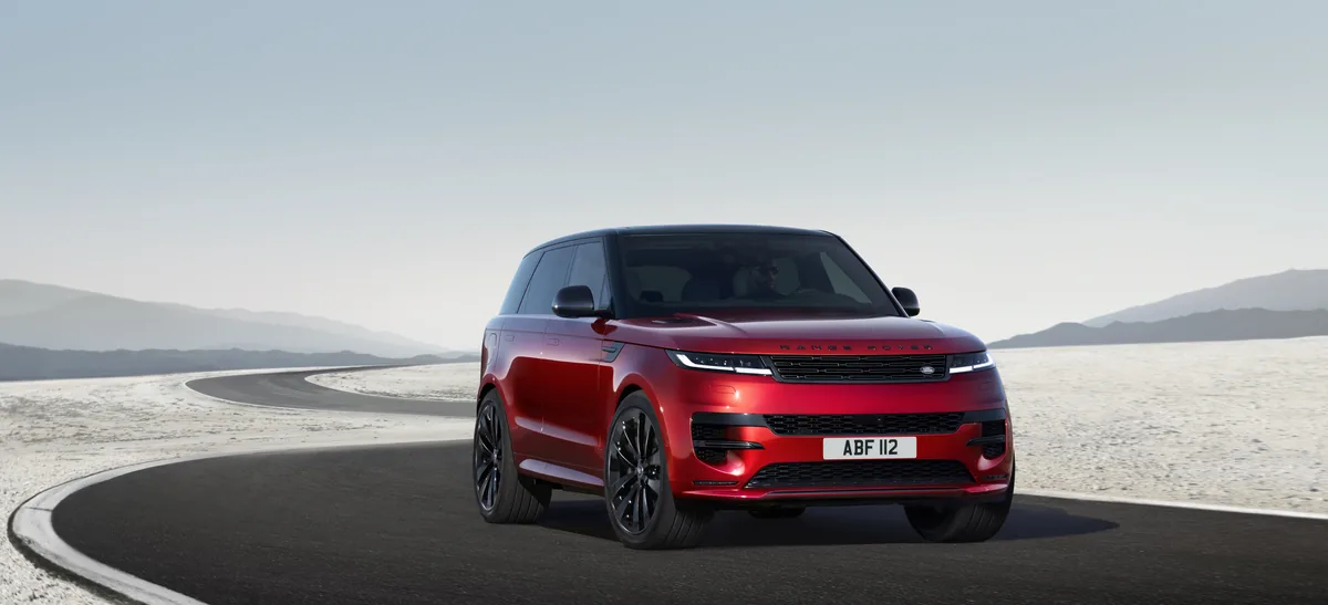 Red Range Rover Sport driving in a front three-quarter view
