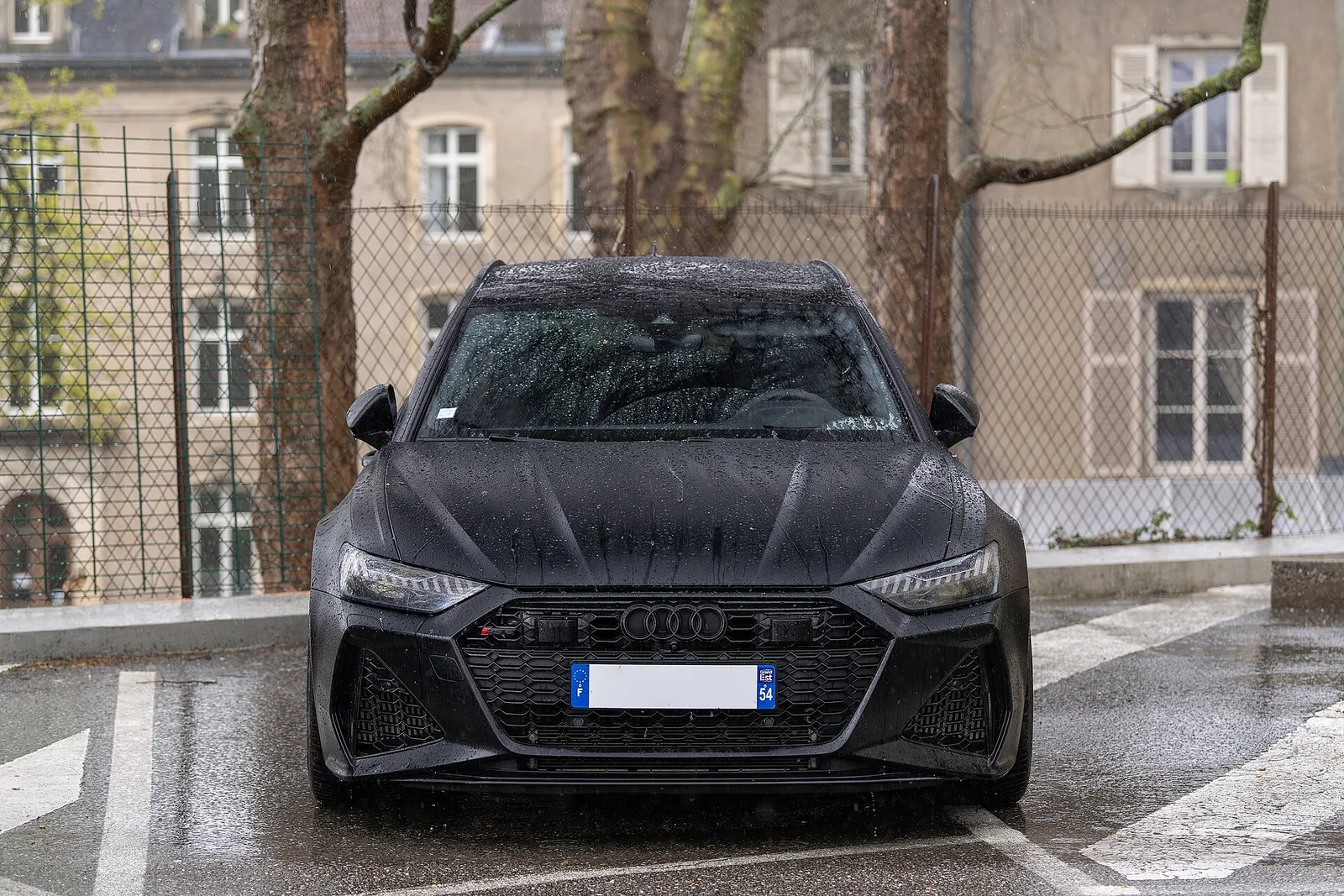 Black Audi RS 6 Avant C8 photographed outdoors in wet weather
