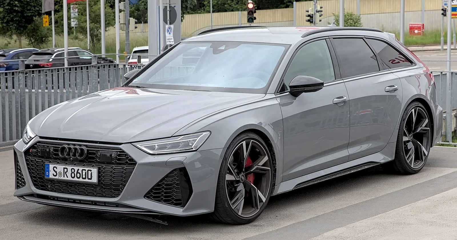 Gray Audi RS 6 Avant C8 front three-quarter view beside a road