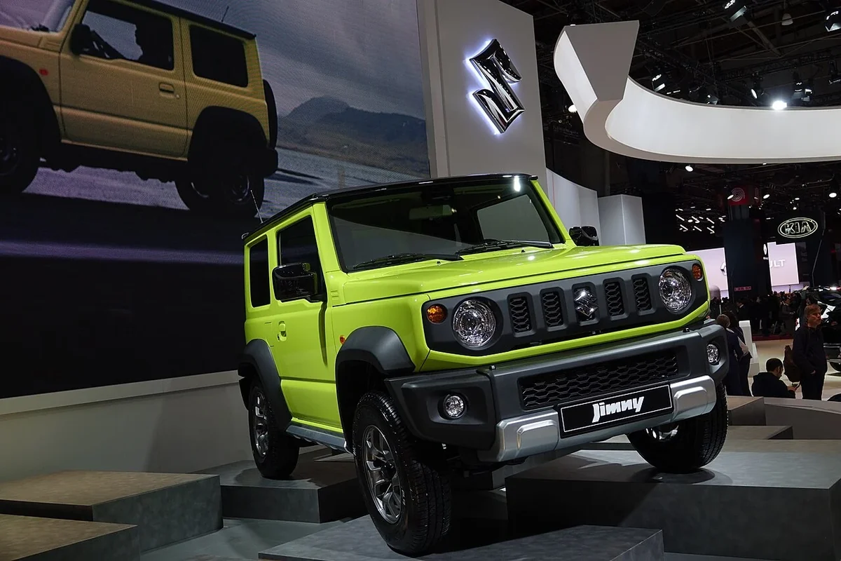 2018 export-generation Jimny front three-quarter view, showing its compact off-road identity.