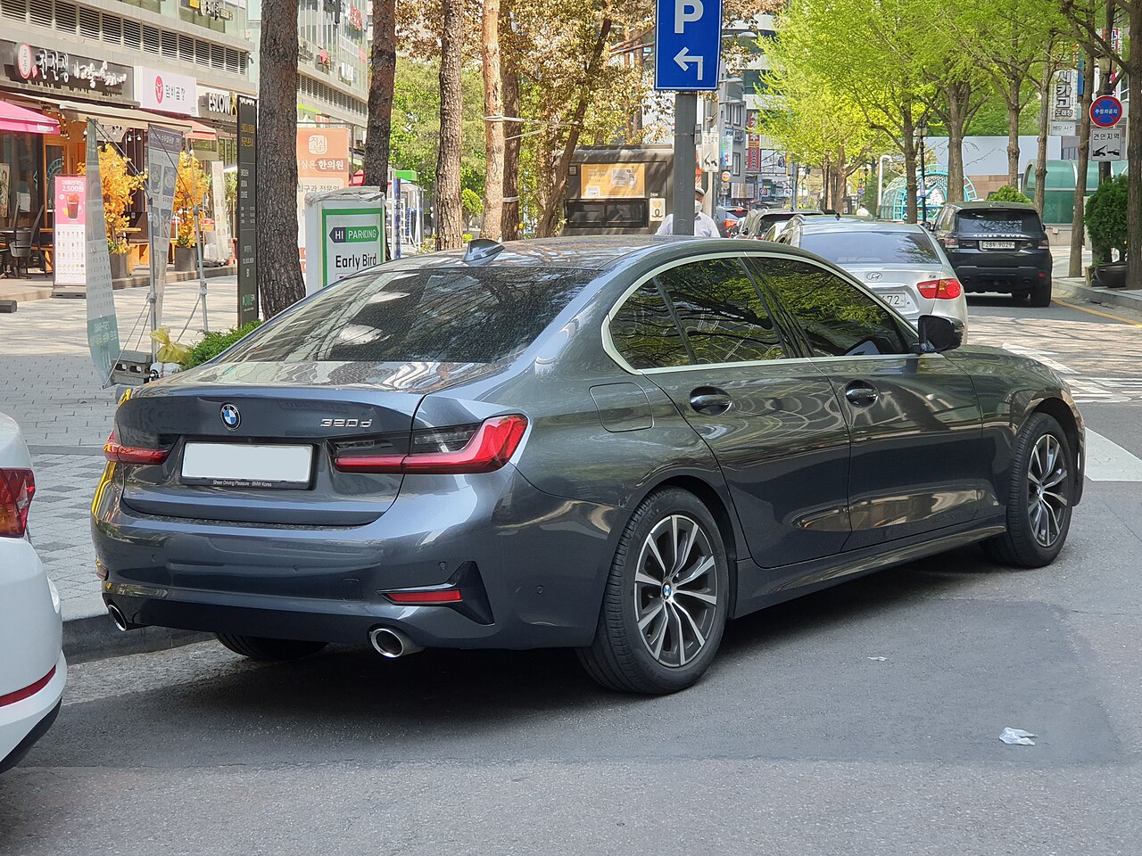 BMW 320d Mineral Grey rear three-quarter view on a street