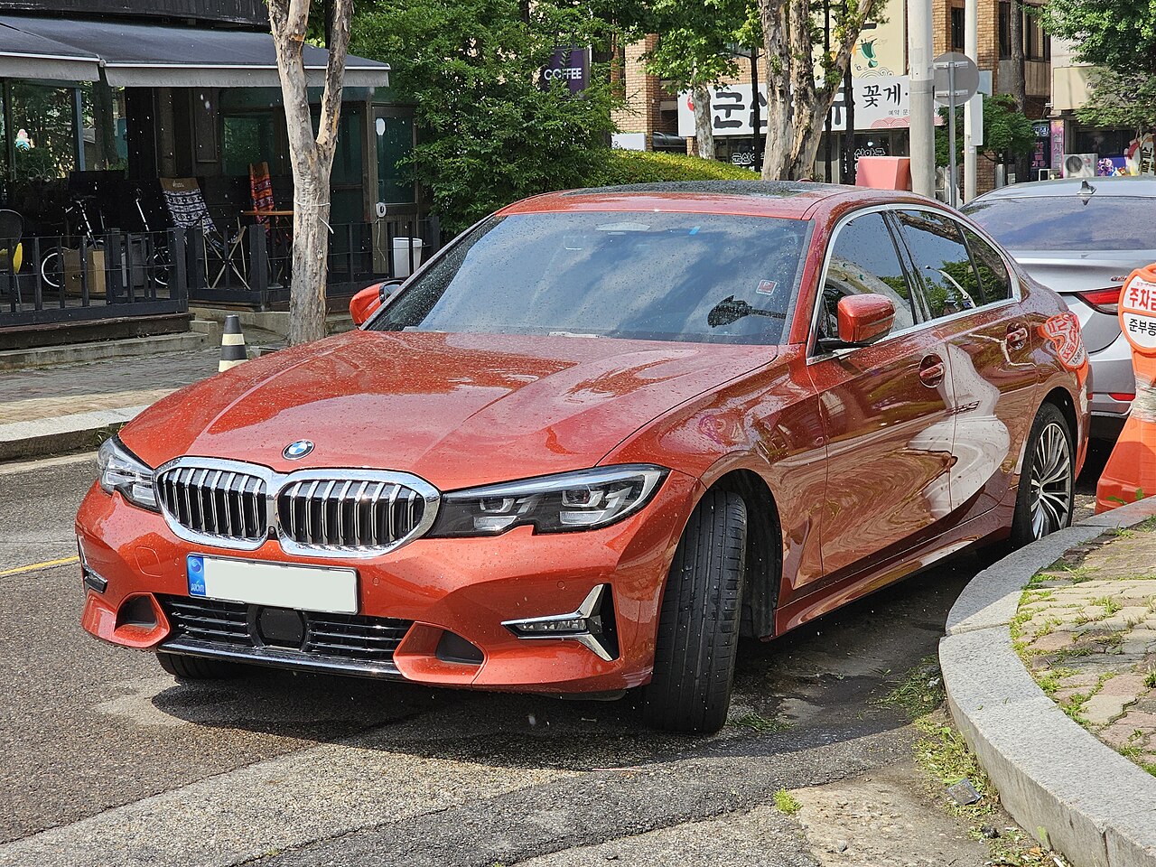 BMW 320d Sunset Orange Luxury Line front three-quarter view