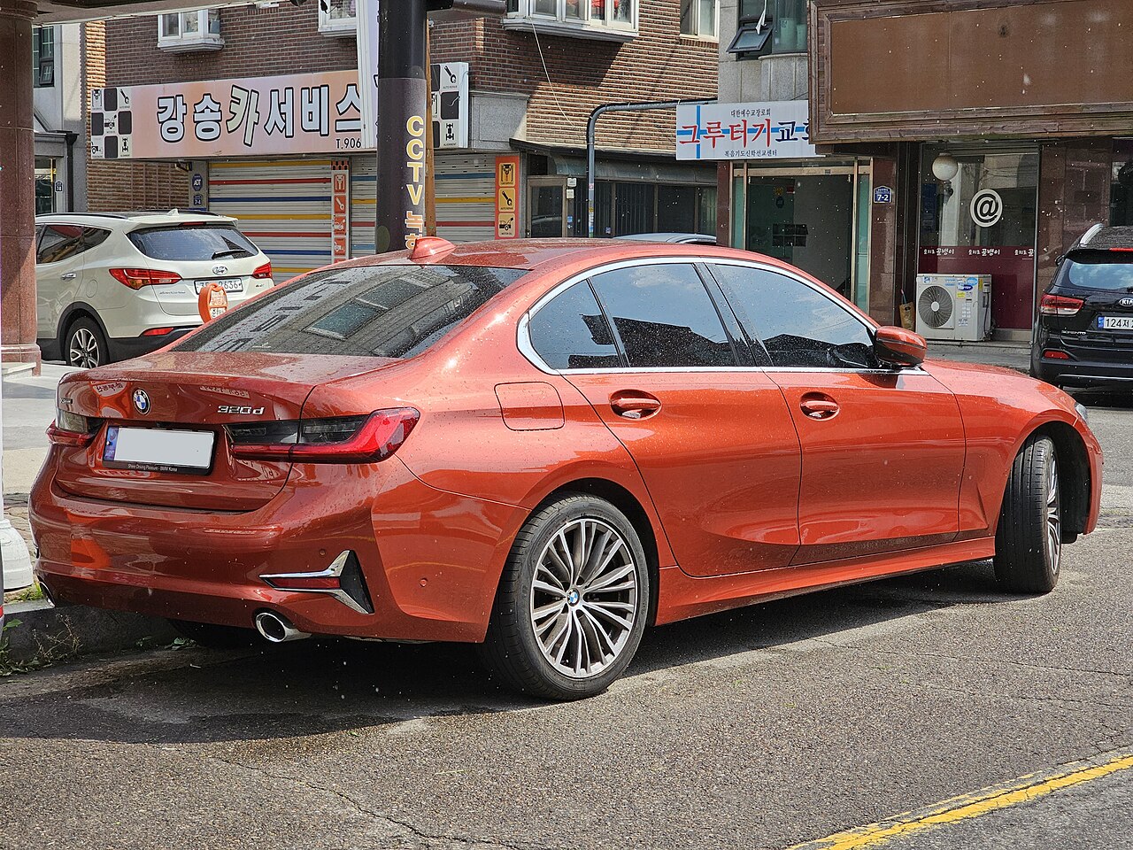 BMW 320d Sunset Orange Luxury Line rear three-quarter view