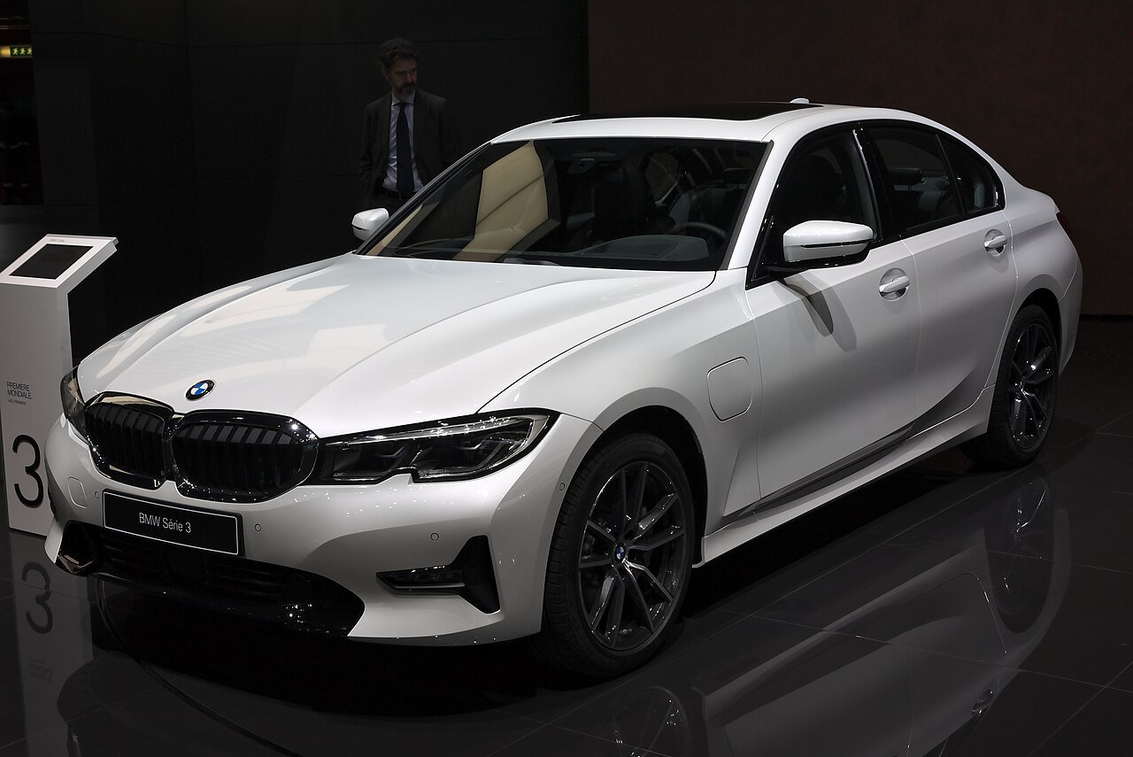BMW 330e white 2019 front-left view with charging flap
