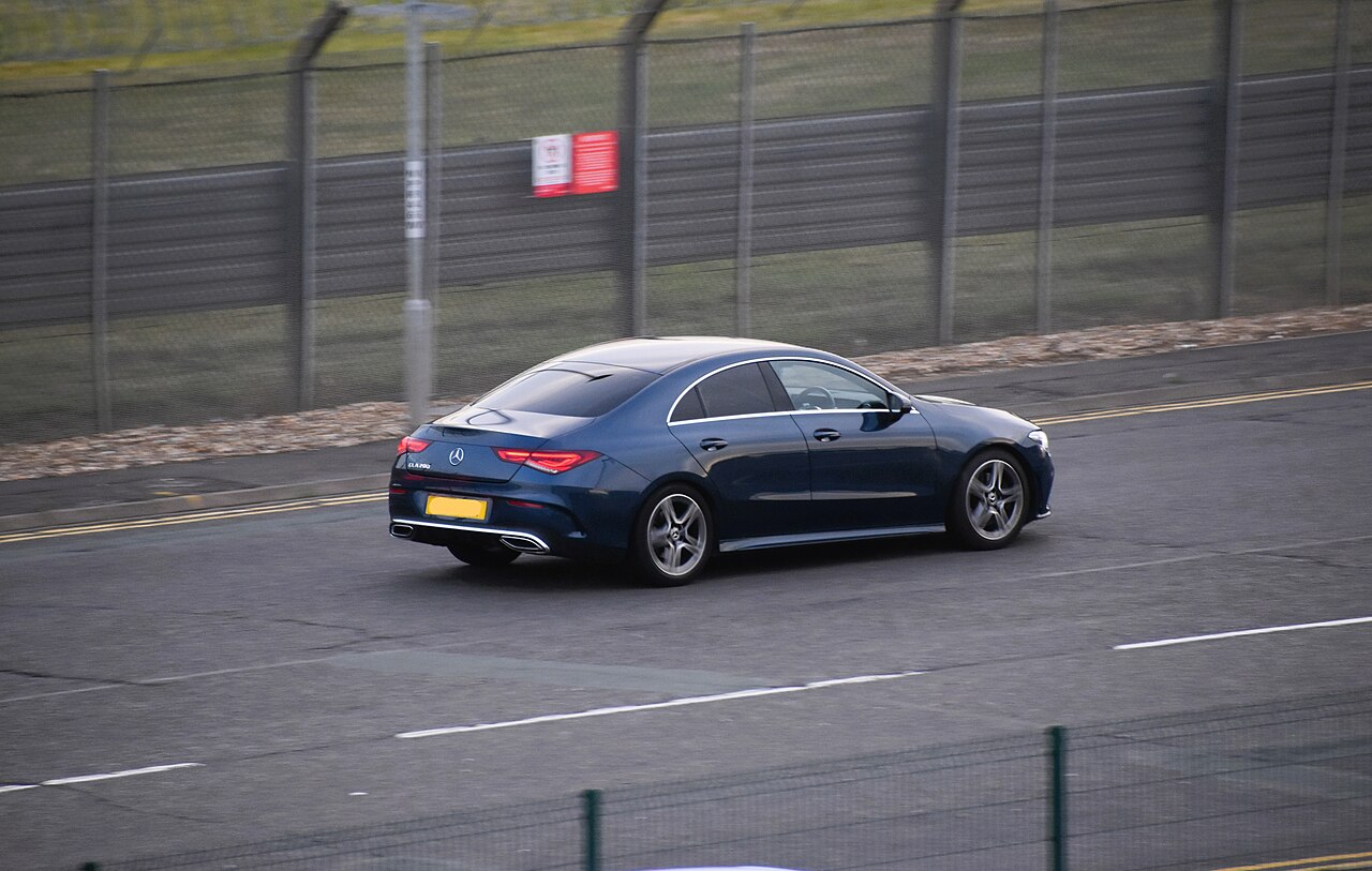 Blue early C118 CLA 200 on the road from behind