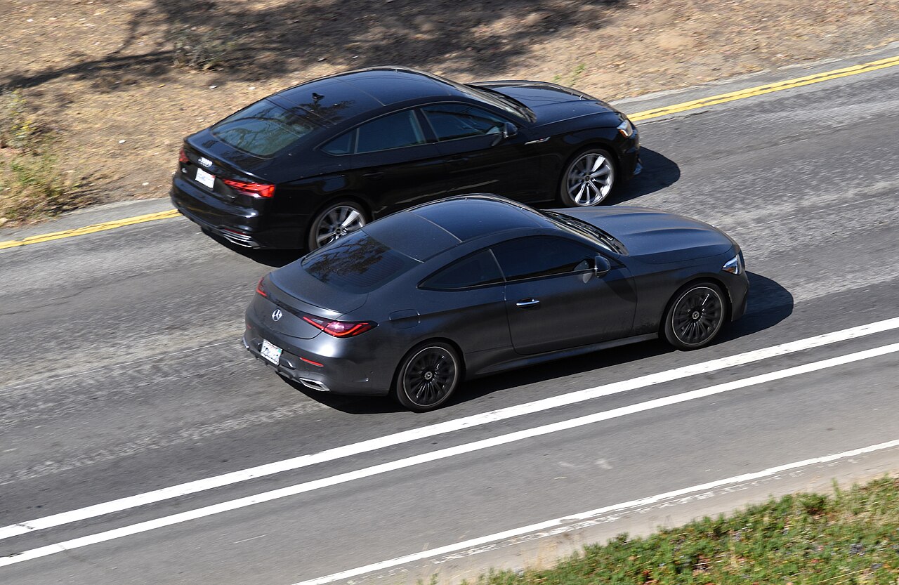 Grey C236 CLE 300 coupe side and rear view on the road