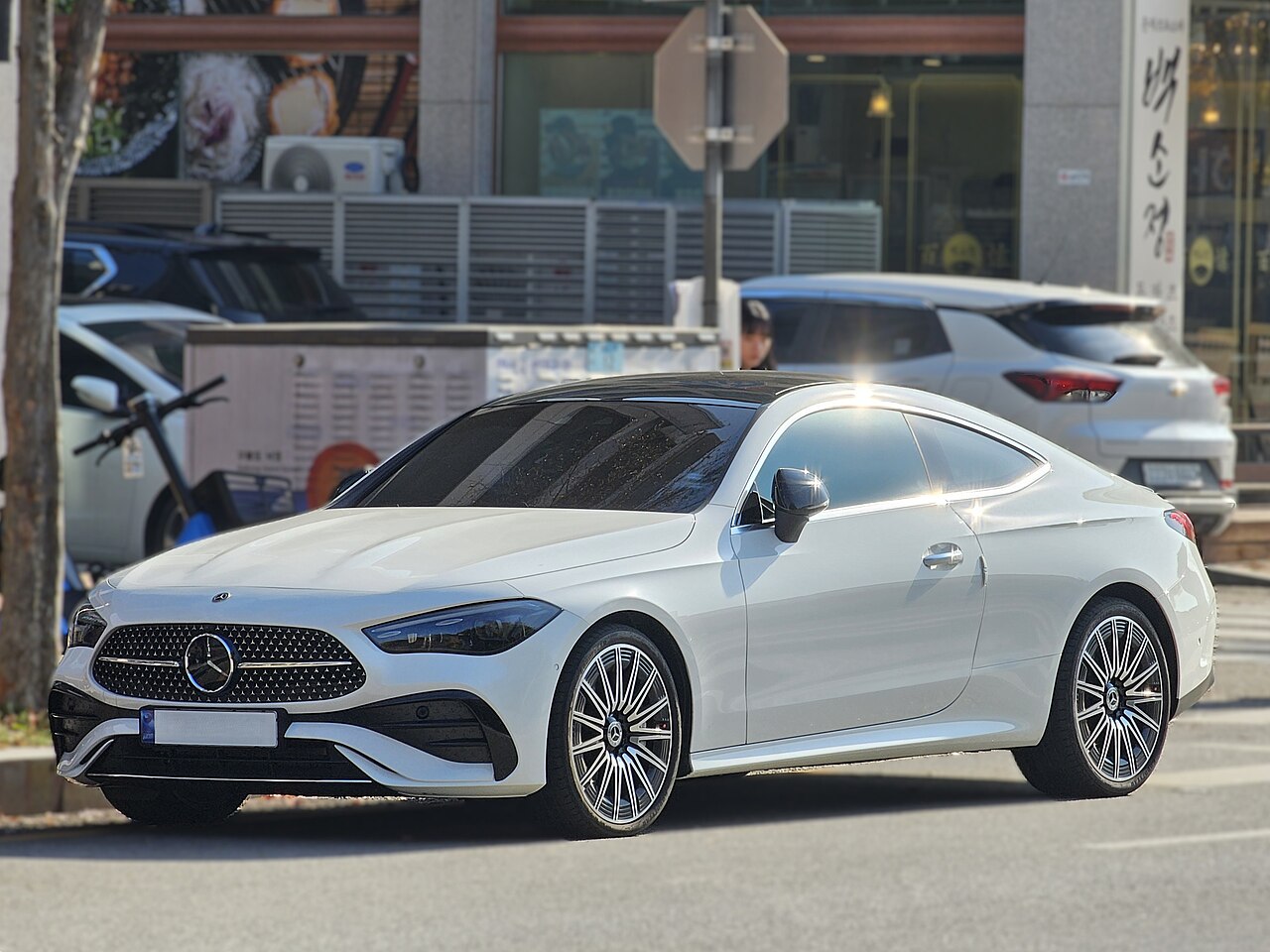 White C236 CLE 450 4MATIC coupe front three-quarter view