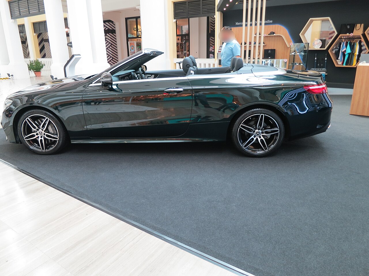 Dark green A238 E 300 Cabriolet side view with roof down