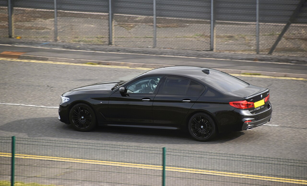 Black early G30 BMW 520d side and rear on the road