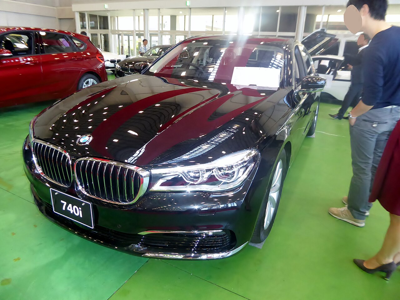 Black early G11 BMW 740i display car front view
