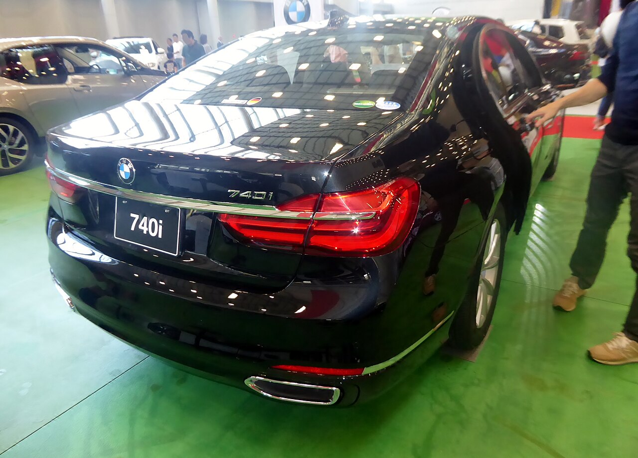 Black early G11 BMW 740i display car rear view
