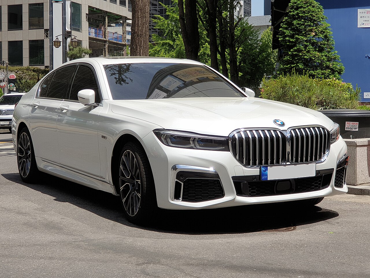 White facelift BMW 745e plug-in hybrid front view