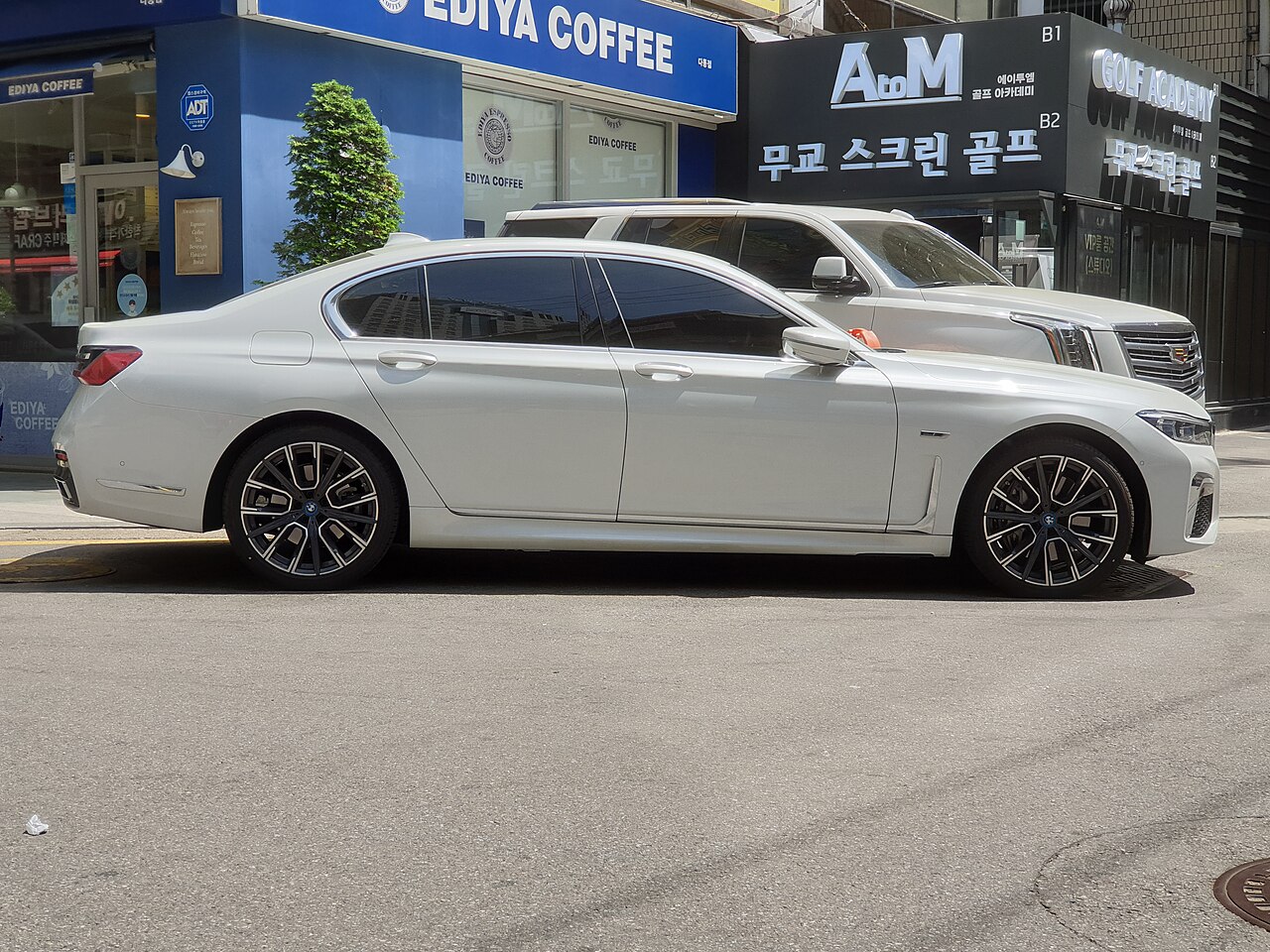 White facelift BMW 745e saloon side profile