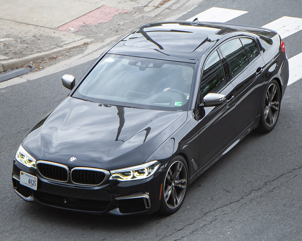 Dark early G30 BMW M550i xDrive front view from above