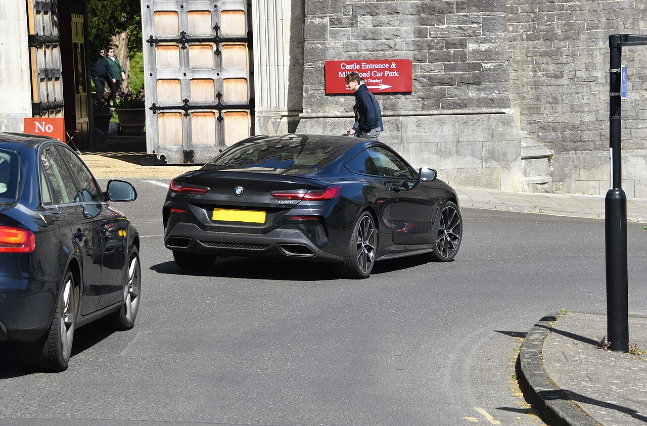 Black BMW 840i G15 Coupe from the rear