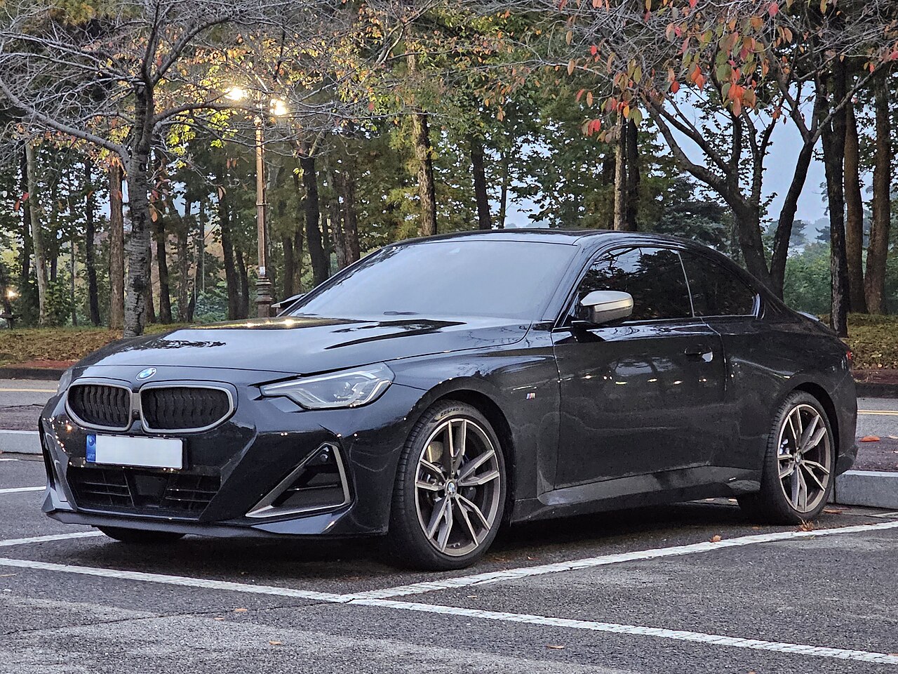 Black BMW M240i xDrive G42 Coupe front and side
