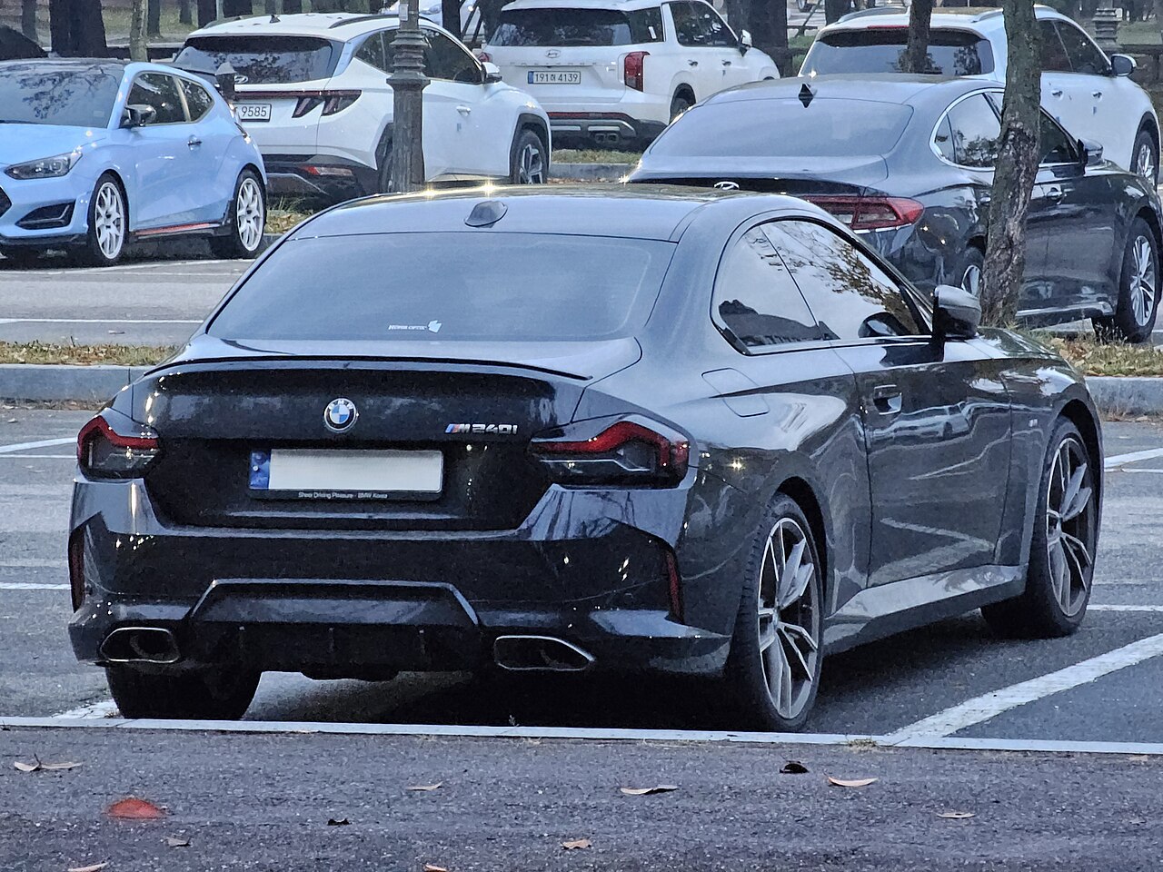Black BMW M240i G42 Coupe rear and side