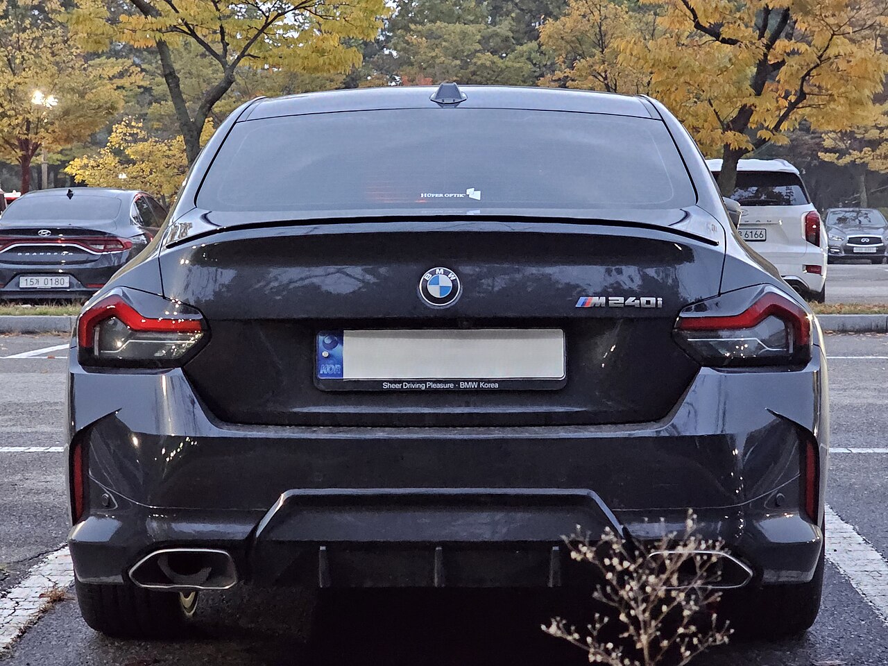 Black BMW M240i G42 direct rear view with badge