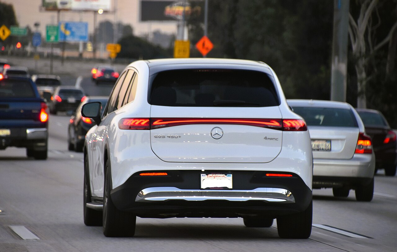 White Mercedes-Benz EQS 450 4MATIC X296 rear on a road