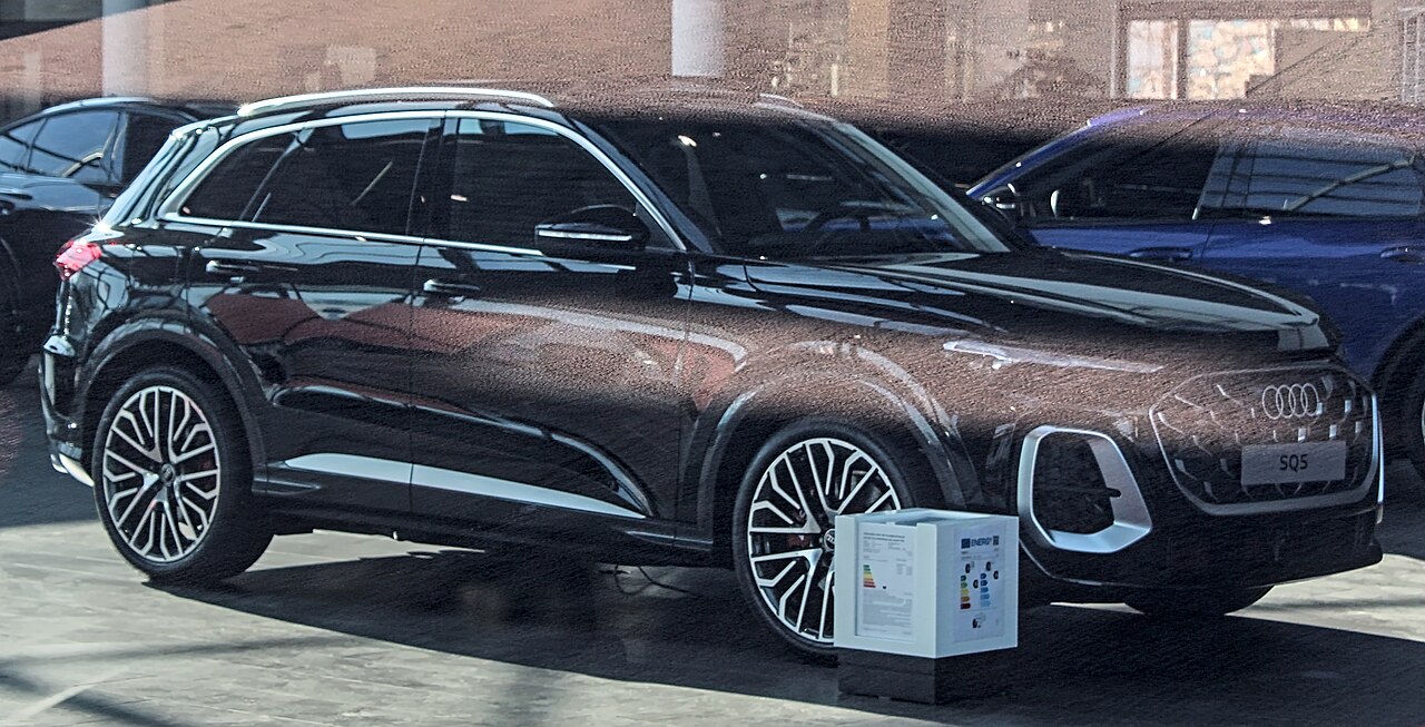 Brown Audi SQ5 GU SUV behind showroom glass