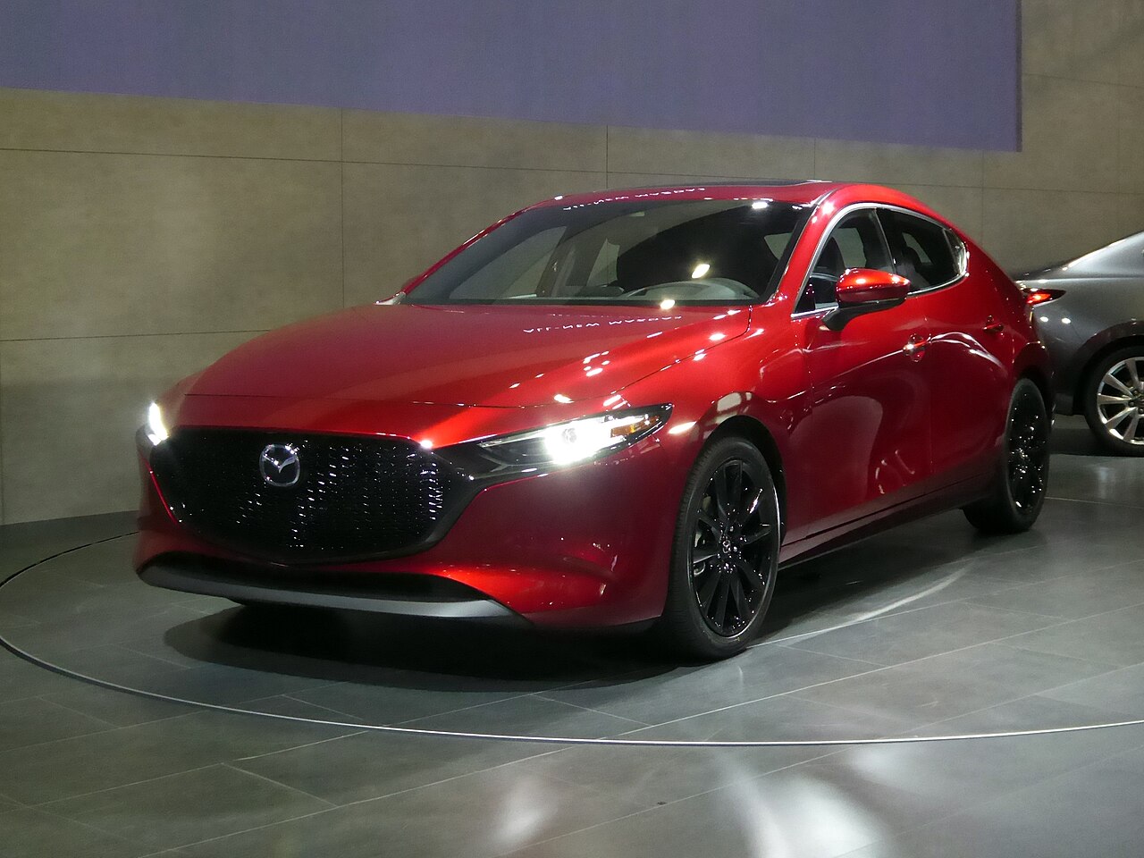 Red Mazda3 BP hatchback at Osaka Auto Messe 2019