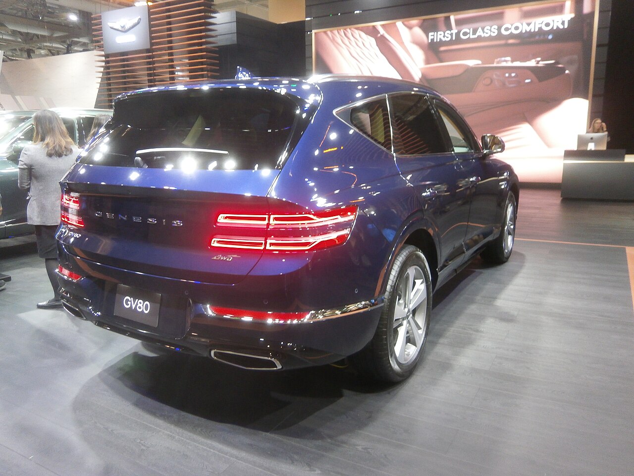 Blue 2021 Genesis GV80, rear three-quarter view