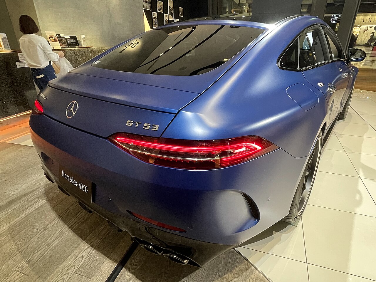 Blue Mercedes-AMG GT 53 X290, rear three-quarter view